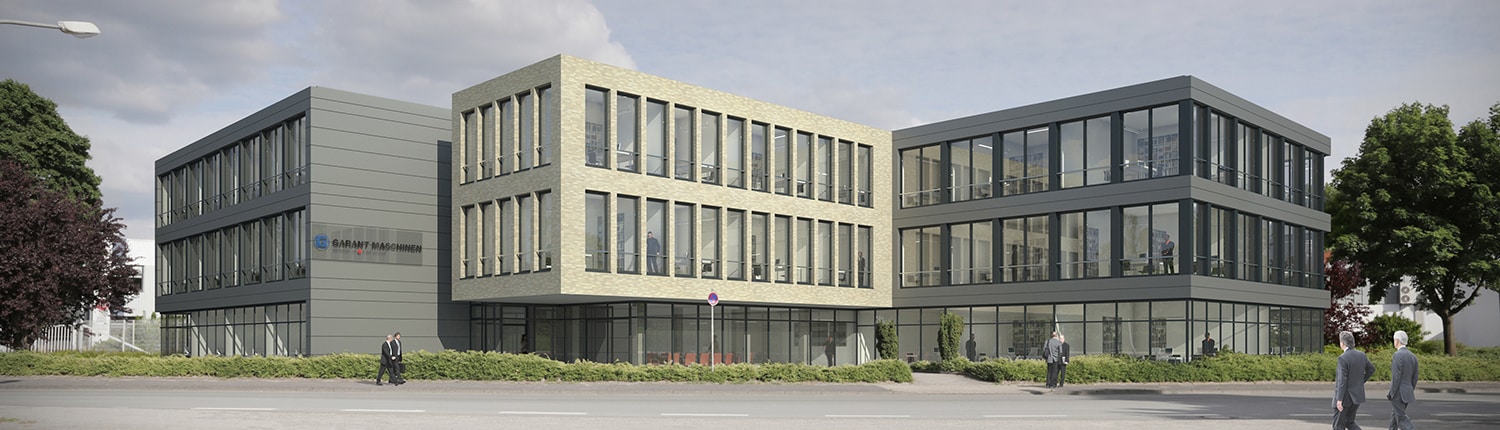 Modernes Bürogebäude mit großen Fenstern und einer Mischung aus hellem Backstein und grauer Fassade, umgeben von Grün. Draußen sind mehrere Menschen unterwegs, der Himmel ist klar.